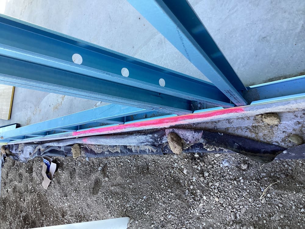 Slab protrudes beyond timber wall by over 20mm trim the slab, recorded during a slab pre-pour inspection in Greenbank